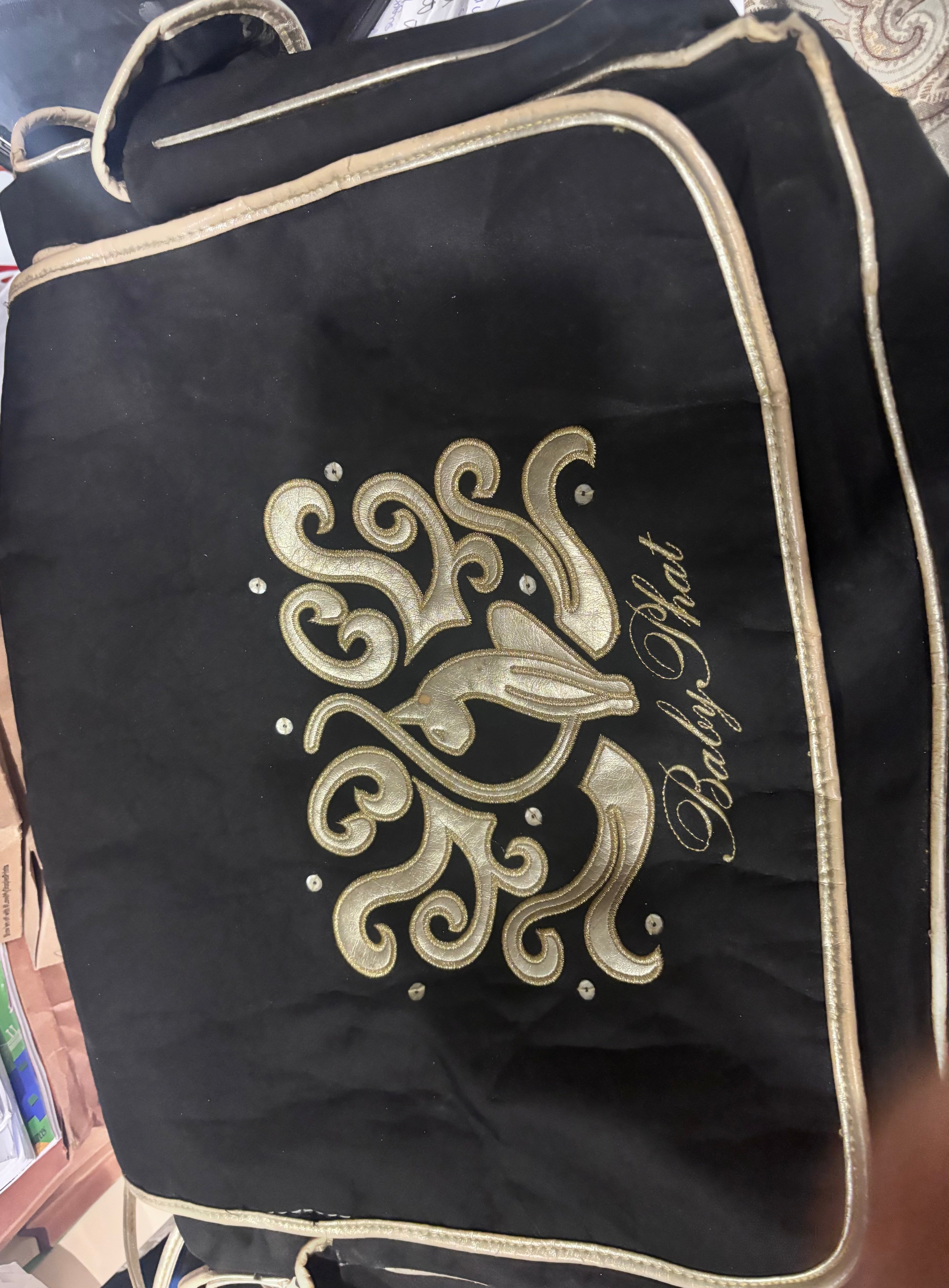 Gently used Baby Phat diaper bag, black and gold